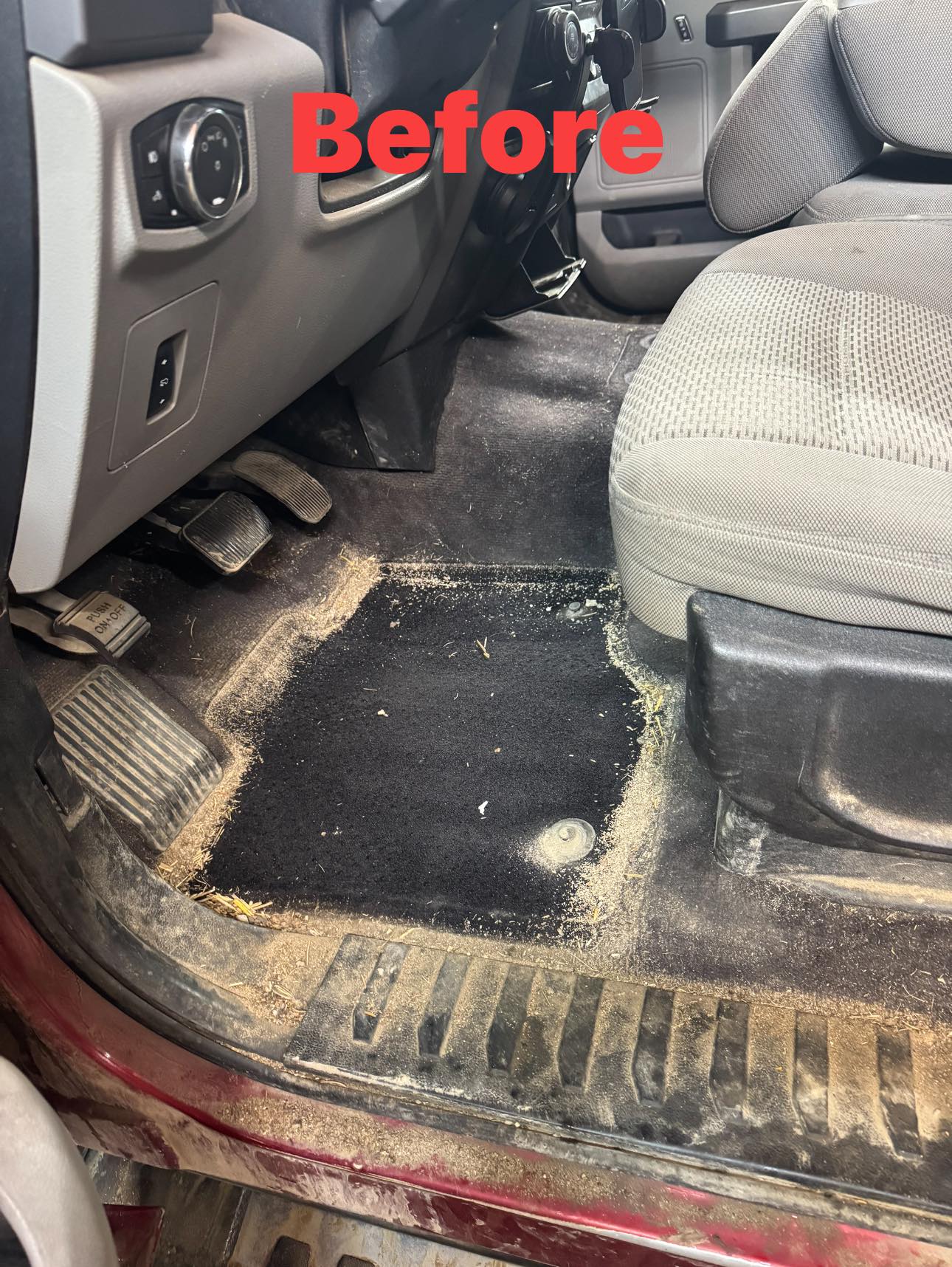 Truck floor before detailing with visible dirt around the pedals and footwell.